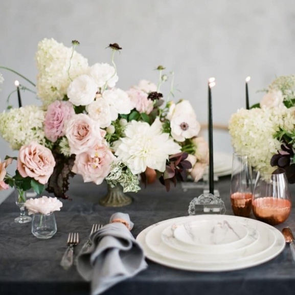 Candles and flowers blend perfectly into this elegant wedding table setting!